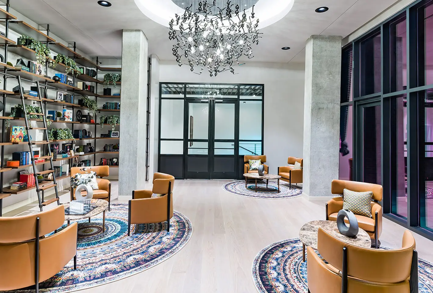 Stylish reading area featuring modern furniture, open bookshelves, and warm decorative lighting