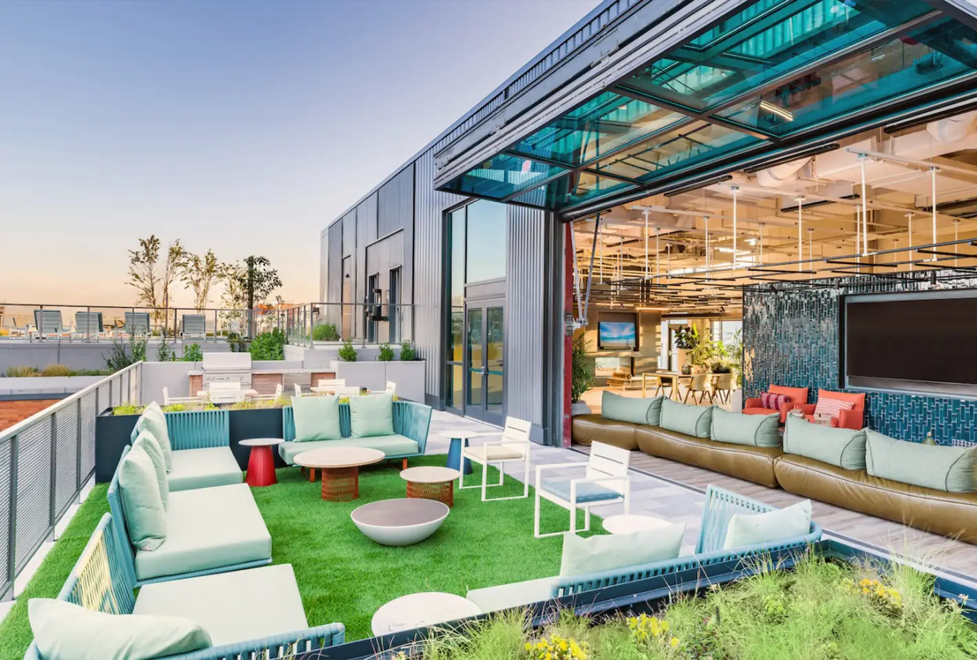 Outdoor rooftop lounge showcasing chic furnishings, expansive views, and cozy seating arrangements