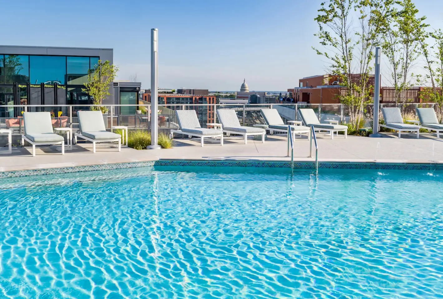 Rooftop pool with crystal-clear water, sun loungers, and city views for ultimate relaxation