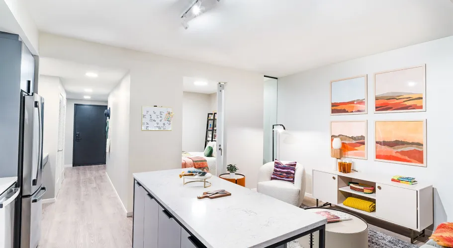 Modern apartment interior featuring decorative accents, sleek furnishings, and colorful wall art