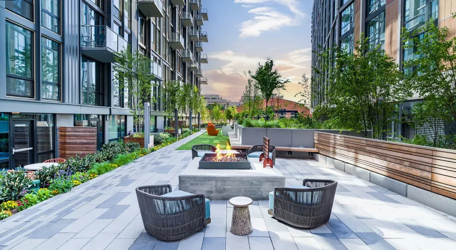 Scenic garden patio with a fire pit, contemporary seating, and urban high-rise views