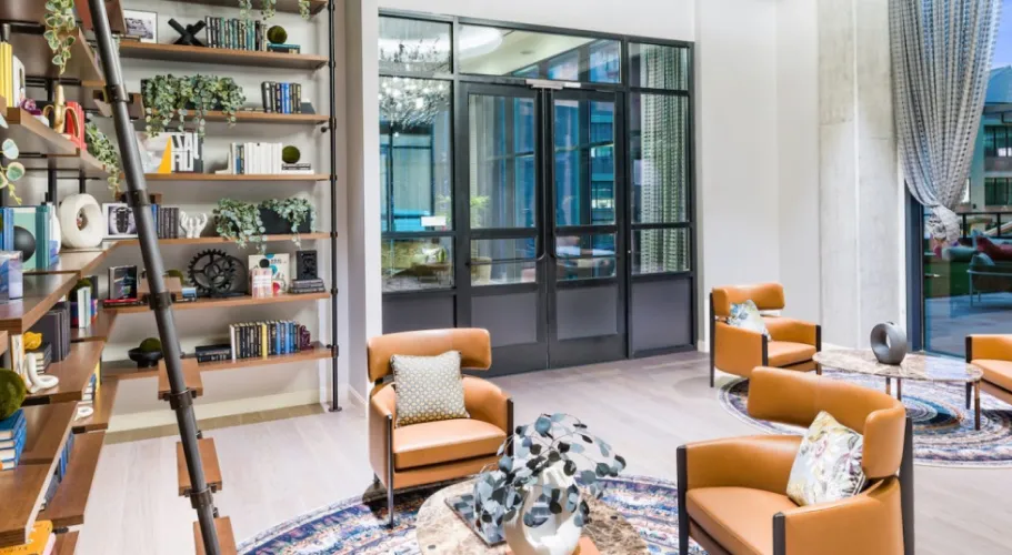 Modern seating area featuring a curated bookshelf, leather accents, and a sophisticated ambiance