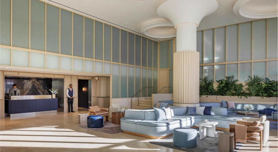 Sophisticated hotel lobby with contemporary design, indoor greenery, and ample natural light