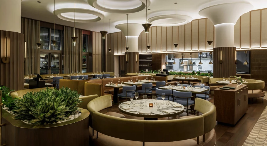 Luxurious dining area showcasing modern decor, lush plants, and artistic ceiling design