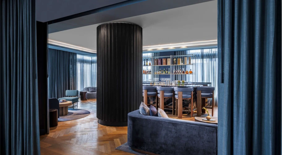 Sophisticated bar and lounge space featuring chic seating, contemporary decor, and soft lighting