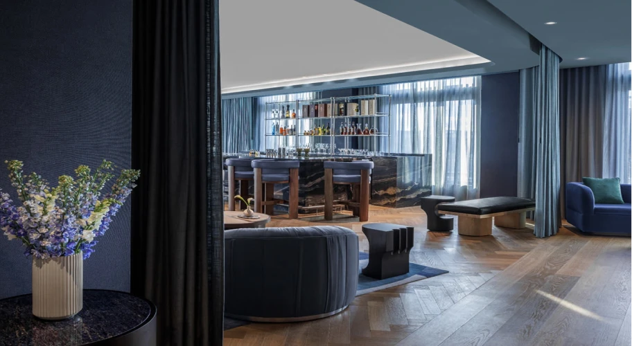 Elegant lounge area with stylish bar, cozy furnishings, and ambient lighting