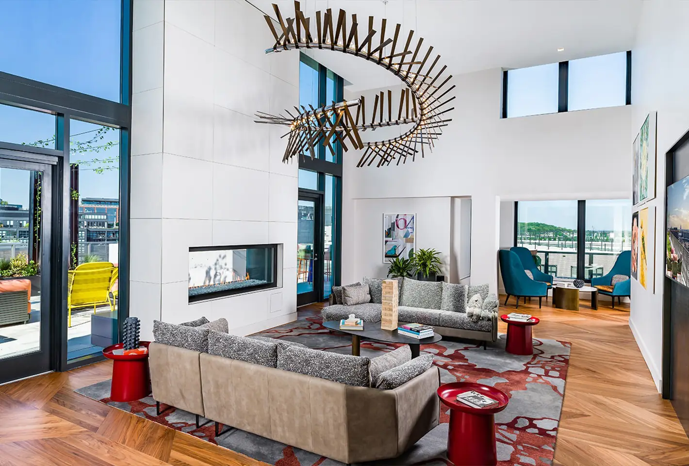 Sophisticated communal area featuring contemporary furniture and large windows for bright ambiance