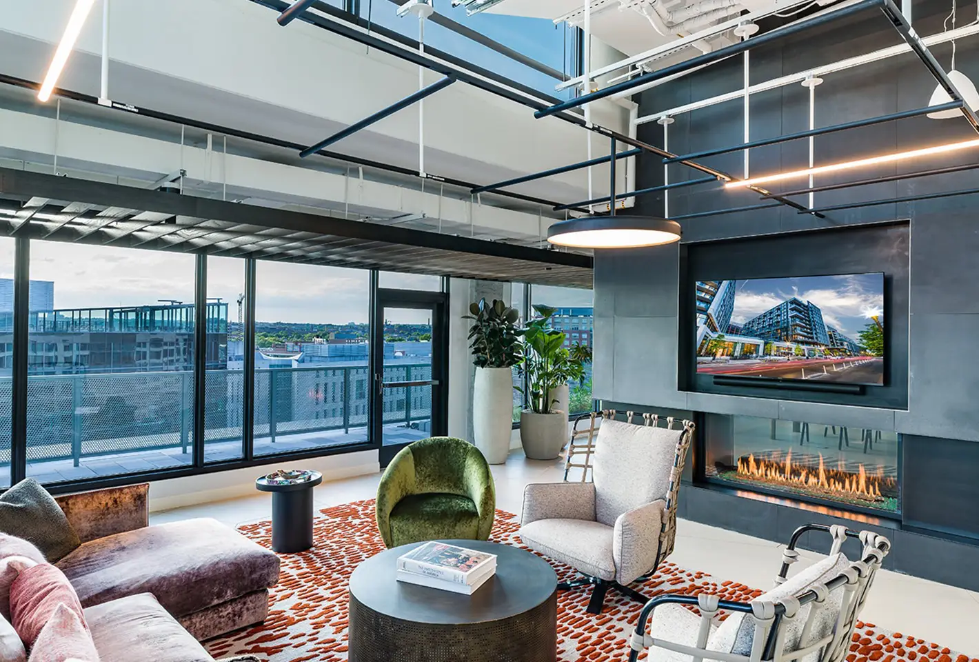 Luxurious rooftop space with sleek furniture, greenery, and evening lighting enhancing urban elegance