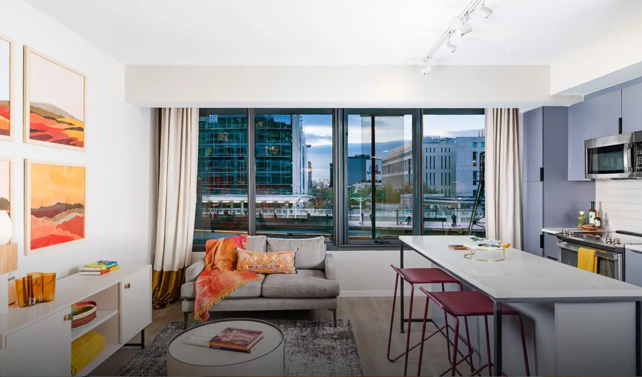 Bright apartment living space with contemporary furnishings and city views