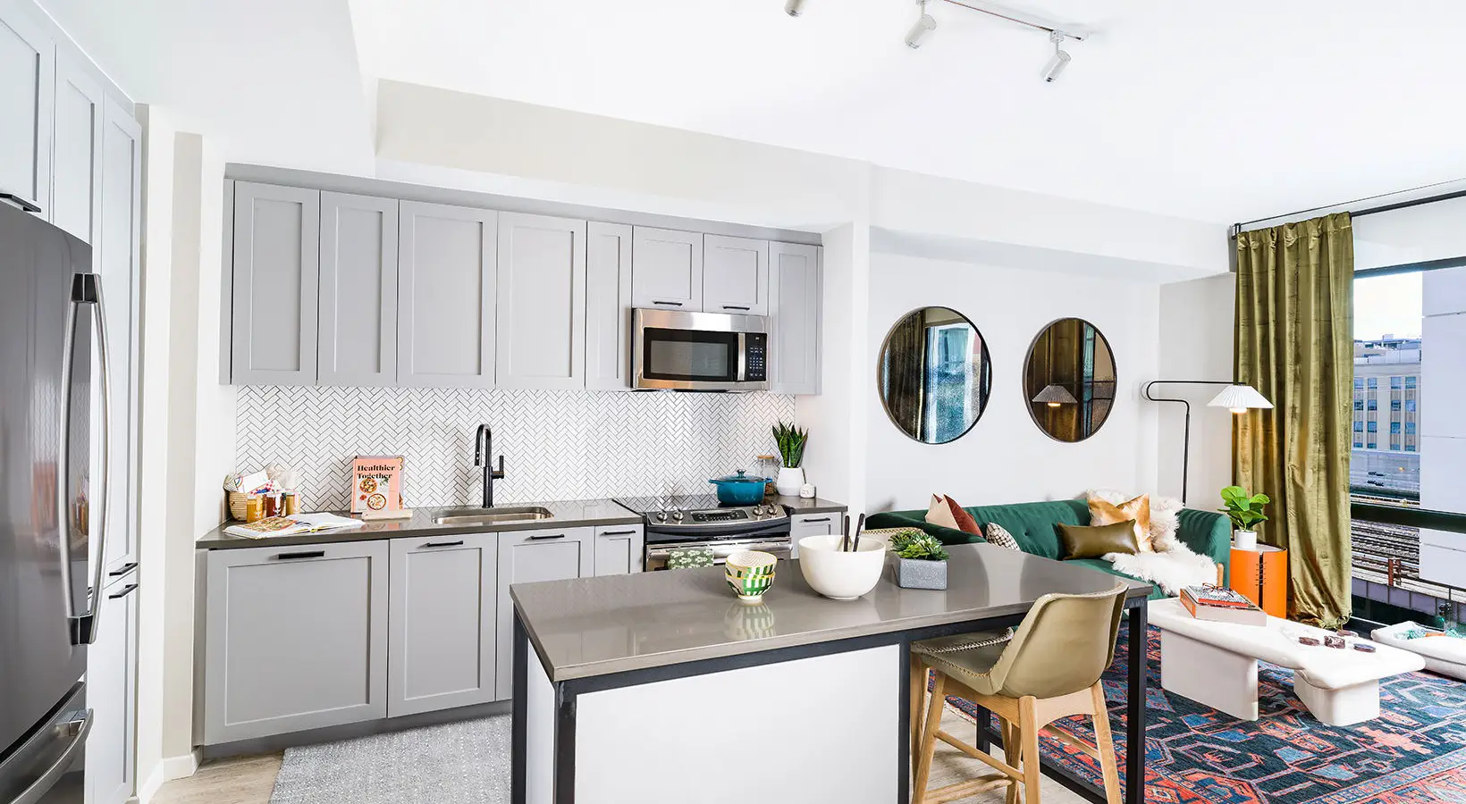 Open-concept kitchen and living area with cozy seating and modern decor elements