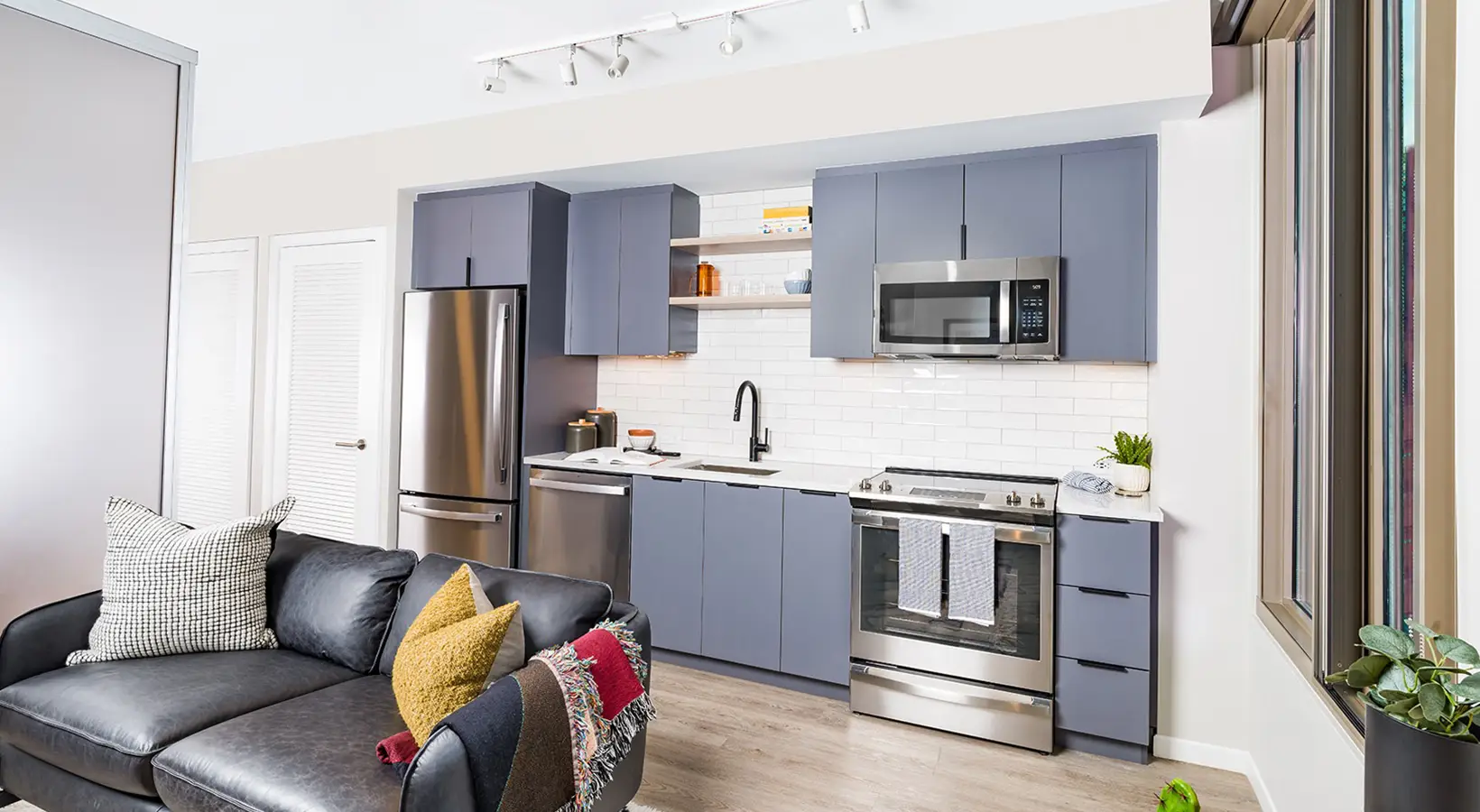 Modern studio apartment featuring open kitchen layout and bright natural light