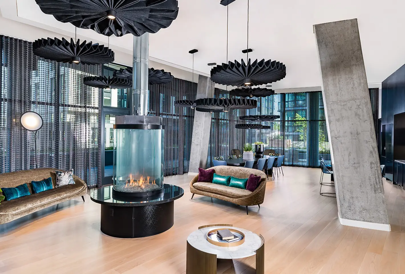 Sophisticated lounge with unique ceiling design, central fireplace, and plush seating