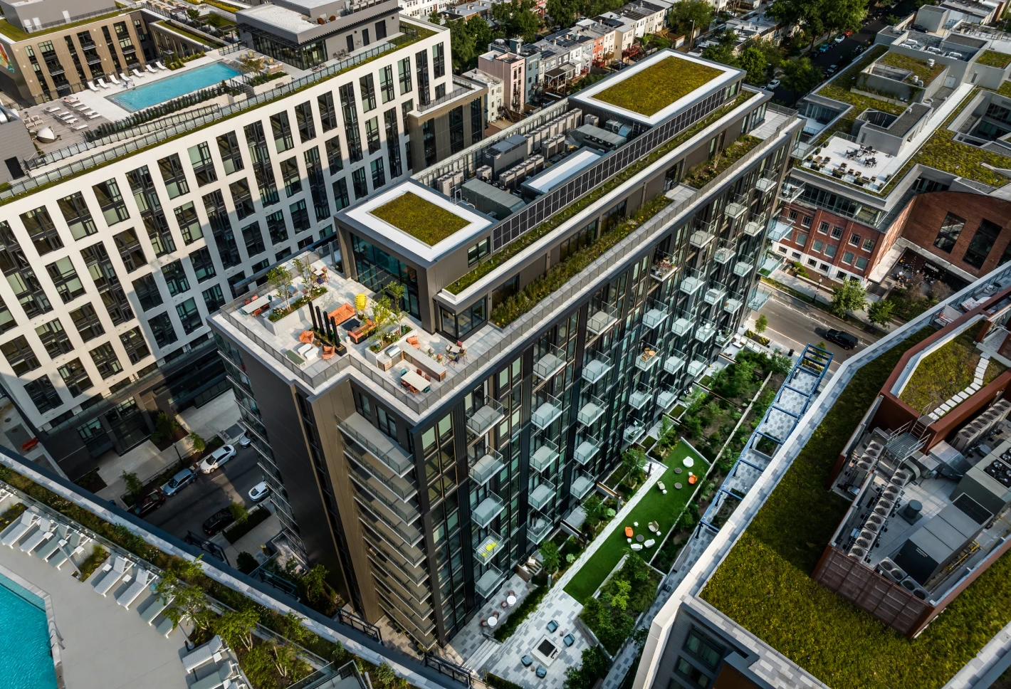 Aerial view of modern building with rooftop green spaces and terraces