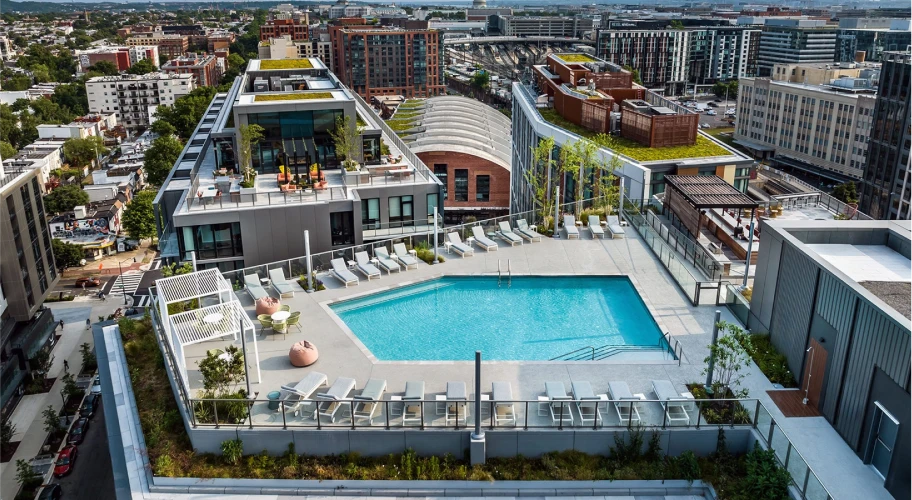 Luxury rooftop pool deck offering stunning urban scenery and modern outdoor furnishings