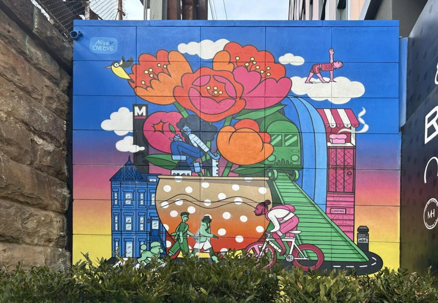 Bold city mural with giant flowers, cyclists, and whimsical illustrations on gradient background